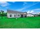 Well-maintained backyard with a lush green lawn, fence, and a screened porch at 3148 Gause Rd., Loris, SC 29569