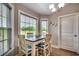 Bright dining area featuring views from three windows and a modern chandelier at 3148 Gause Rd., Loris, SC 29569