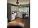 Country kitchen with white cabinets and a large window overlooking the backyard at 3293 Schoolhouse Dr., Hemingway, SC 29554
