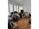 Bright living room with multiple windows offering ample natural light and hardwood floors at 3293 Schoolhouse Dr., Hemingway, SC 29554
