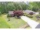 An aerial view of a home with lush landscaping and a long driveway leading to the main house and a secondary dwelling at 33 Brassie Dr., Carolina Shores, NC 28467