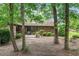Backyard with trees and patio with grill and furniture at 33 Brassie Dr., Carolina Shores, NC 28467