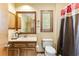 Bathroom with a vanity, toilet, and shower with a patterned curtain at 33 Brassie Dr., Carolina Shores, NC 28467