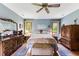 Relaxing bedroom with a ceiling fan, natural lighting, and classic decor at 33 Brassie Dr., Carolina Shores, NC 28467