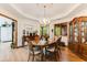 Elegant dining room with chandelier, adjacent to kitchen, for easy serving and entertaining at 33 Brassie Dr., Carolina Shores, NC 28467