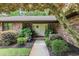 Inviting front entrance with double doors, lush landscaping, brick facade, and a welcoming pathway at 33 Brassie Dr., Carolina Shores, NC 28467