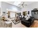 Bright and airy living room with skylight, hardwood floors, comfortable seating, and views of the foyer at 33 Brassie Dr., Carolina Shores, NC 28467