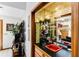 Unique wet bar featuring a red sink, mirrored backsplash, glass shelving, and decorative lighting at 33 Brassie Dr., Carolina Shores, NC 28467