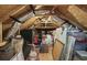 Unfinished attic space showing exposed beams and storage items at 3381 Pampas Dr., Myrtle Beach, SC 29577