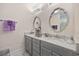 Elegant bathroom with double sinks, vanity with granite counters, and stylish mirrors at 3381 Pampas Dr., Myrtle Beach, SC 29577