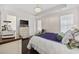 Well-lit bedroom with dark wood floors, tray ceilings, and a cozy seating area at 3381 Pampas Dr., Myrtle Beach, SC 29577