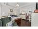 Bright bedroom featuring tray ceiling, hardwood floors, and elegant furnishings at 3381 Pampas Dr., Myrtle Beach, SC 29577