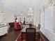 Open concept dining room with a decorative chandelier, dark wood floors, and a large window with custom drapery at 3381 Pampas Dr., Myrtle Beach, SC 29577