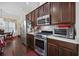Well-equipped kitchen with stainless steel appliances, dark wood cabinets, and an adjacent dining area at 3381 Pampas Dr., Myrtle Beach, SC 29577