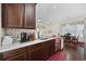Functional kitchen with dark wood cabinets, stainless steel appliances, and quartz countertops open to the dining room at 3381 Pampas Dr., Myrtle Beach, SC 29577