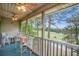 Relaxing covered balcony overlooking a lush golf course and serene water feature at 342 Pinehurst Ln. # 12J, Pawleys Island, SC 29585