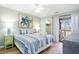 Bright bedroom with comfortable bedding, large windows, closet and access to the patio at 342 Pinehurst Ln. # 12J, Pawleys Island, SC 29585