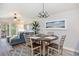 Open-concept dining area with stylish table set, artwork, and seamless flow into the cozy living room at 342 Pinehurst Ln. # 12J, Pawleys Island, SC 29585
