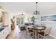 Well-lit dining area next to the living room, featuring stylish decor and access to the outdoor balcony at 342 Pinehurst Ln. # 12J, Pawleys Island, SC 29585