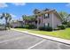 Attractive condo building featuring green shutters and palm trees adjacent to a parking area at 342 Pinehurst Ln. # 12J, Pawleys Island, SC 29585