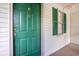 Condo front door with green paint, gold accents, and decorative shutters on an adjacent window at 342 Pinehurst Ln. # 12J, Pawleys Island, SC 29585