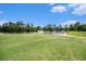 Scenic view of a golf course with a pond and sandy beach area at 342 Pinehurst Ln. # 12J, Pawleys Island, SC 29585