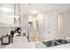 Bright kitchen features white cabinets, stainless sink, modern appliances, and hallway access at 342 Pinehurst Ln. # 12J, Pawleys Island, SC 29585