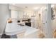 Galley kitchen equipped with white appliances, spacious countertops, and easy access to a laundry closet at 342 Pinehurst Ln. # 12J, Pawleys Island, SC 29585