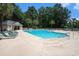 Community pool area with lounge chairs, umbrellas, and a pool house at 342 Pinehurst Ln. # 12J, Pawleys Island, SC 29585