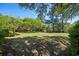 Spacious backyard with lush green grass and mature trees provides a serene outdoor setting at 352 Old Carriage Loop, Georgetown, SC 29440