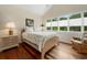 Comfortable bedroom featuring hardwood floors, neutral walls, and a large sunny window at 352 Old Carriage Loop, Georgetown, SC 29440