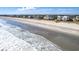 Coastal community showcasing beach homes along a sandy shoreline with crashing ocean waves at 352 Old Carriage Loop, Georgetown, SC 29440