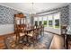Elegant dining room with hardwood floors, blue wallpaper, and large bay window at 352 Old Carriage Loop, Georgetown, SC 29440