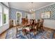 Formal dining room with hardwood floors, blue floral wallpaper, and wine storage at 352 Old Carriage Loop, Georgetown, SC 29440