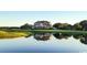 Luxury home reflecting on a pond, positioned on a golf course at 352 Old Carriage Loop, Georgetown, SC 29440