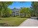 Charming home with manicured lawn, mature landscaping and driveway leads to the front entrance at 352 Old Carriage Loop, Georgetown, SC 29440
