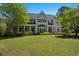 Beautiful two-story home with manicured lawn and mature landscaping at 352 Old Carriage Loop, Georgetown, SC 29440