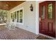 Inviting front porch with rocking chairs and brick flooring at 352 Old Carriage Loop, Georgetown, SC 29440