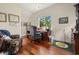 Well-lit home office with hardwood floors, large window, and traditional furnishings at 352 Old Carriage Loop, Georgetown, SC 29440