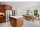 Bright eat-in kitchen boasts stainless steel appliances, an island, and ample cabinet space at 352 Old Carriage Loop, Georgetown, SC 29440
