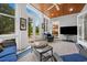 Relaxing sunroom with wood plank ceiling features comfortable seating and views of the lush backyard at 352 Old Carriage Loop, Georgetown, SC 29440