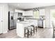 Bright kitchen features white cabinets, stainless steel appliances, granite countertops, and a center island with seating at 355 Myrtle Meadows Dr # B, Conway, SC 29526