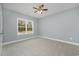 Cozy bedroom with neutral walls, carpet, ceiling fan, and a bright window at 357 Log Cabin Rd., Loris, SC 29569