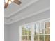 The primary bedroom features a trey ceiling, a ceiling fan, crown molding and large windows at 357 Log Cabin Rd., Loris, SC 29569