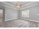 Spacious bedroom with light gray walls, ceiling fan and trim and a bright window at 357 Log Cabin Rd., Loris, SC 29569