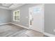 Bright entryway featuring a white door with glass panes, light gray walls, and wood-look floors at 357 Log Cabin Rd., Loris, SC 29569
