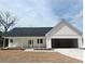 Charming single-story home featuring a covered porch, attached two-car garage and neutral color palette at 357 Log Cabin Rd., Loris, SC 29569