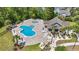 Aerial view of a community pool, lounge area, and clubhouse surrounded by lush greenery at 3725 Park Pointe Ave., Little River, SC 29566