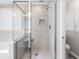 An elegant glass walk-in shower with a bench and tiled walls at 3725 Park Pointe Ave., Little River, SC 29566