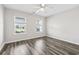 This bedroom has natural light from the two windows, a ceiling fan, and wood-look flooring at 3725 Park Pointe Ave., Little River, SC 29566
